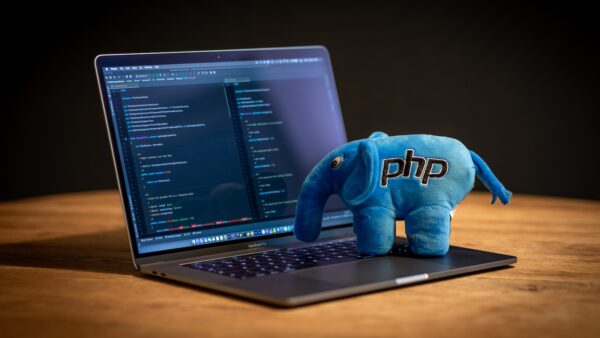blue elephant plush toy on black laptop computer